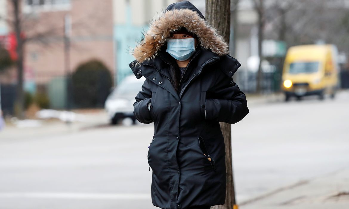FILE PHOTO: A woman wears a mask in Chinatown following the outbreak of the novel coronavirus, in Chicago, Illinois, U.S. January 30, 2020. REUTERS/Kamil Krzaczynski/File Photo