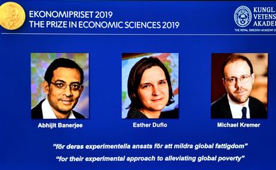 The portraits of Abhijit Banerjee, Esther Duflo, and Michael Kreme, who have been announced the Nobel Prize in Economic Sciences 2019 winners, are seen at a news conference at the Royal Swedish Academy of Sciences in Stockholm, Sweden, October