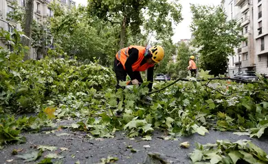 Workers remove broken tree branches in a street the day after a heavy storm hit Paris, France, June 26, 2025. REUTERS/Benoit Tessier