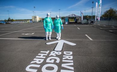 Medical workers stand next to the drive-through mobile testing side for the coronavirus disease (COVID-19) in Bydgoszcz