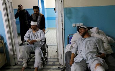 Wounded men are treated inside a hospital in Kabul