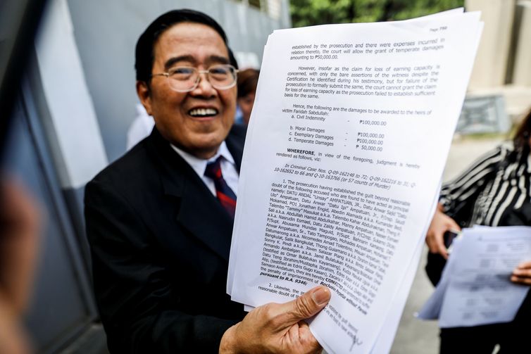 A lawyer of a victim's family shows the page of the decision citing guilt of the primary suspects in the 2009 Maguindanao Massacre case after its promulgation in Taguig City, Metro Manila, Philippines, December 19, 2019. REUTERS/Eloisa Lopez