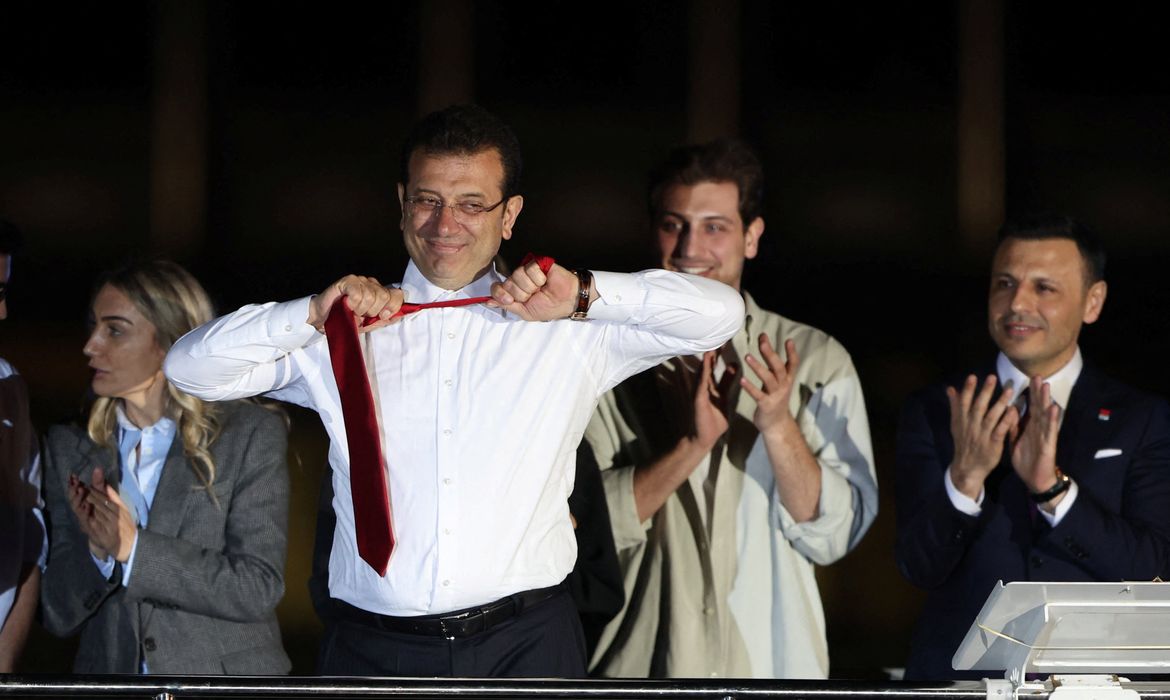 Istanbul Mayor Ekrem Imamoglu, mayoral candidate of the main opposition Republican People's Party (CHP), takes off his tie as he addresses his supporters following the early results in front of the Istanbul Metropolitan Municipality (IBB) in Istanbul, Turkey April 1, 2024. REUTERS/Umit Bektas