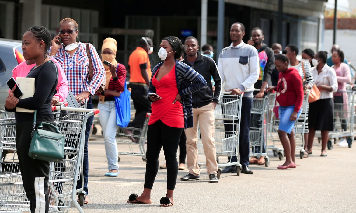 FILE PHOTO: People queue to shop ahead of a nationwide 21 day lockdown called by the government to limit the spread of coronavirus disease (COVID-19) in Harare