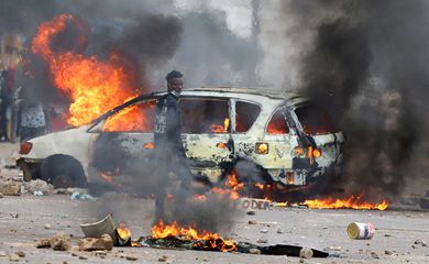 FILE PHOTO: A protester looks on near a burning barricade during a 