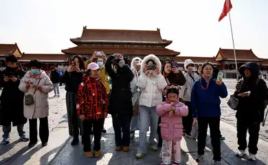 Turistas tiram fotos em Pequim
 21/2/2025   REUTERS/Tingshu Wang