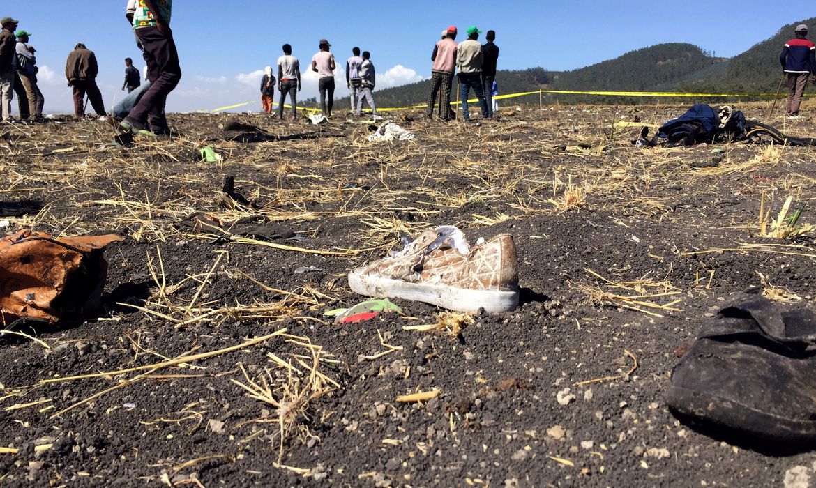 People walk at the scene of the Ethiopian Airlines Flight ET 302 plane crash, near the town of Bishoftu, southeast of Addis Ababa, Ethiopia March 10, 2019. REUTERS/Tiksa Negeri     TPX IMAGES OF THE DAY