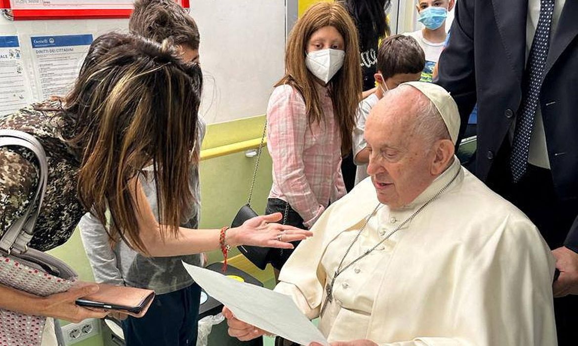 Pope Francis speaks to a person as he visits the children at the paediatric oncology department of Gemelli hospital, in Rome, Italy June 15, 2023. REUTERS/Vatican Media