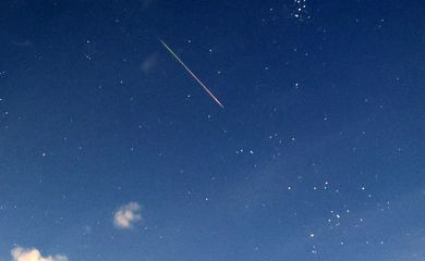 A meteor dashes above Lastavica mountain during the Perseid meteor shower in Radinovici village