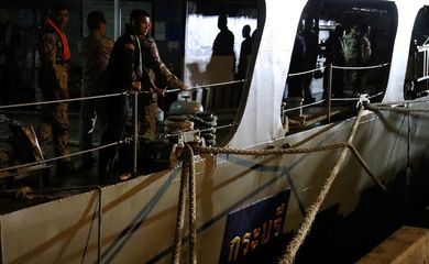 Crew members from Royal Thai Navy are seen docked as they return from a rescue mission after a Navy corvette sank in the Gulf of Thailand