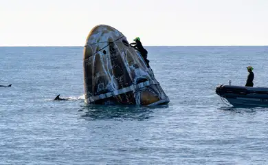 Support teams work around a SpaceX Dragon  spacecraft shortly after it landed with NASA astronauts Nick Hague, Suni Williams, Butch Wilmore, and Roscosmos cosmonaut Aleksandr Gorbunov aboard in the water off the coast of Tallahassee, Florida, Tuesday, March 18, 2025. NASA/Keegan Barber/ Handout via REUTERS