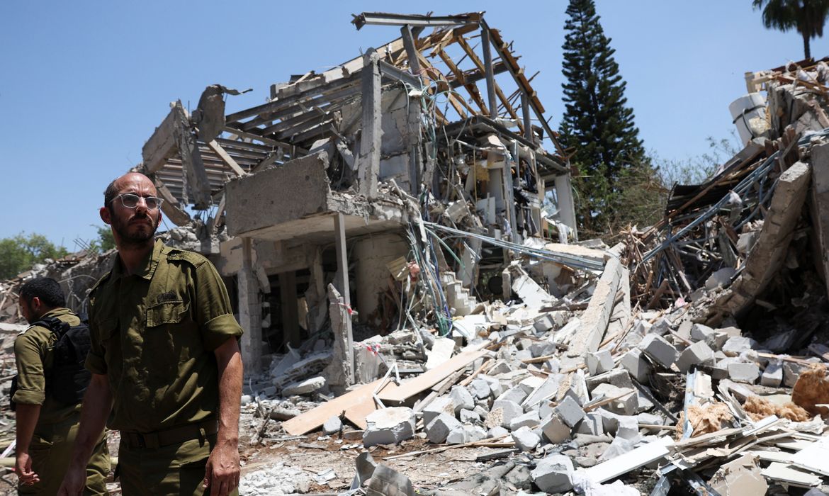Members of Israeli forces work at an impact site following a missile attack from Iran on Israel, amid the Iran-Israel conflict, in Tel Aviv, Israel, June 22, 2025. REUTERS/Violeta Santos Moura