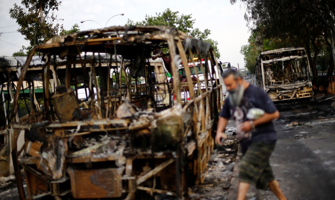 Burned busses are pictured after a protest against the increase in subway ticket prices in Santiago, Chile, October 19, 2019 REUTERS/Edgard Garrido