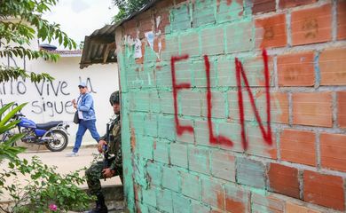 FILE PHOTO: A Colombian soldier leans on a wall while standing guard as members of a humanitarian caravan comprising senators and social organisations, meet with residents, to demand ceasefire and peace , after attacks by rebels from the leftist National Liberation Army (ELN), in the municipality of El Tarra, Colombia February 4, 2025. REUTERS/Carlos Eduardo Ramirez/File Photo