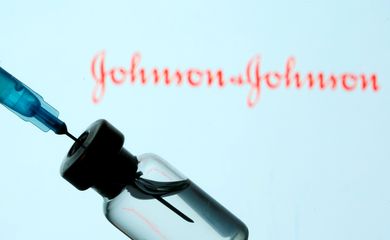 FILE PHOTO: Vial and sryinge are seen in front of displayed Johnson&Johnson logo in this illustration taken