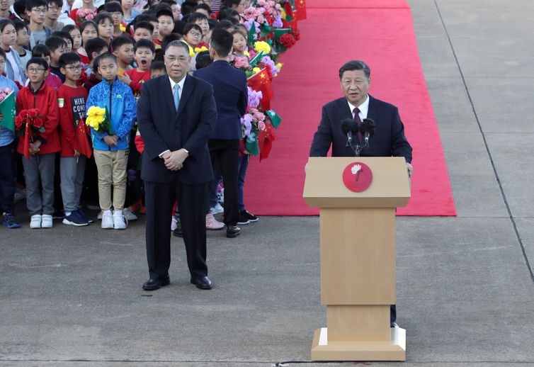 Chinese President Xi Jinping speaks next to outgoing Macau Chief Executive Fernando Chui, upon his arrival at Macau International Airport in Macau, China December 18, 2019, ahead of the 20th anniversary of the former Portuguese colony's return