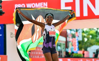 Oct 13, 2024; Chicago, IL, USA; Ruth Chepngetich of Kenya celebrates after finishing first in the women’s race, setting a new world record at 2:09:56 during the Chicago Marathon at Grant Park. Mandatory Credit: Patrick Gorski-Imagn Images