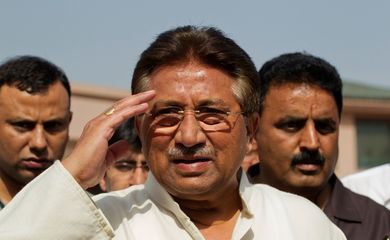 FILE PHOTO: Pakistan's former President and head of the All Pakistan Muslim League (APML) political party Pervez Musharraf salutes as he arrives to unveil his party manifesto for the forthcoming general election at his residence in Islamabad