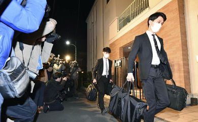 Officials from the Tokyo District Public Prosecutors Office carry bags after raiding the Tokyo residence of former Nissan chairman Carlos Ghosn in Tokyo, Japan in this photo taken by Kyodo January 2, 2020. Mandatory credit Kyodo/via REUTERS