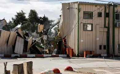 A man handles fallen cables at the Jerusalem headquarters of the United Nations Relief and Works Agency for Palestine Refugees (UNRWA) as the headquarters is dismantled by Israeli forces, in East Jerusalem, January 20, 2026. REUTERS/Ammar Awad
