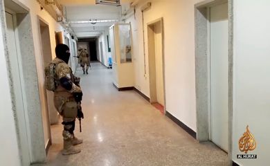 Taliban soldiers are seen in hospital hallway amid reports of hospital explosions in Kabul