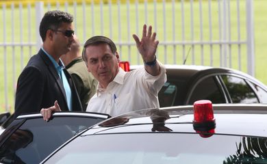 O Presidente Jair Bolsonaro cumprimenta  populares ao sair do Palácio da Alvorada