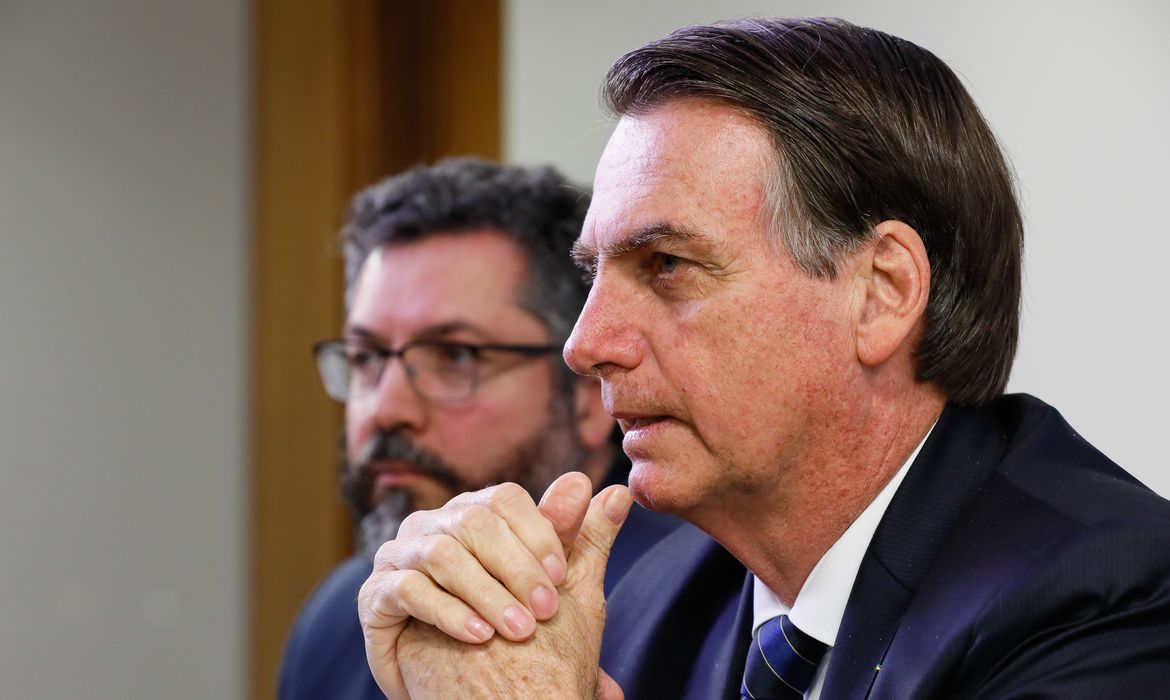 O presidente Jair Bolsonaro faz transmissão ao vivo ao lado do ministro das Relações Exteriores, Ernesto Araújo.