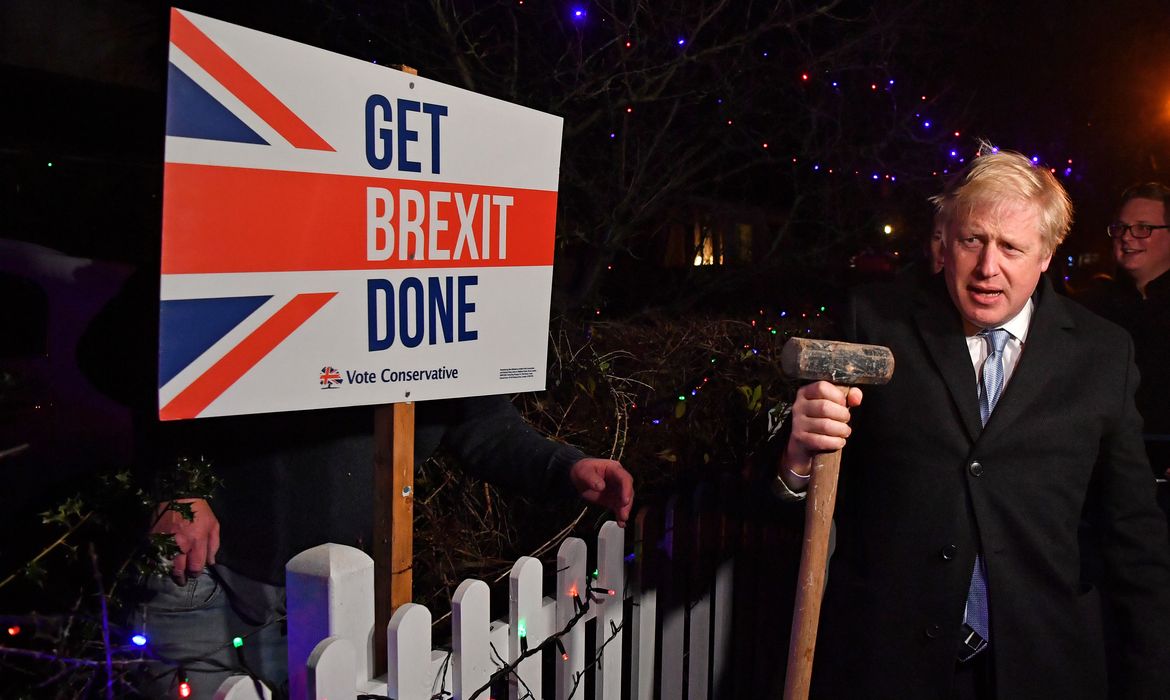 Britain's Prime Minister and Conservative party leader Boris Johnson poses with a sledgehammer, after hammering a 