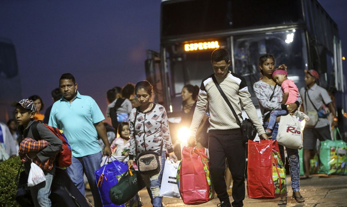 Imigrantes venezuelanos embarcam em avião da Força Aérea Brasileira, em Boa Vista, com destino à Manaus e São Paulo.