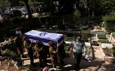 Soldiers carry the coffin of Adi Zur, a soldier who was slain in the assault on Israel by Hamas gunmen from the Gaza Strip, at their funeral at Mount Herzl Military Cemetery in Jerusalem