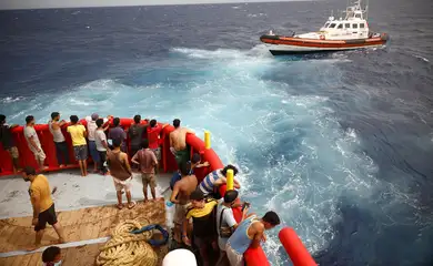 .Pessoas a bordo do barco de resgate da ONG Proactiva Open Arms Uno olham para o barco da guarda costeira indo para a ilha de Lampedusa, no mar Mediterrâneo central, Itália.
19/08/2022
REUTERS/Juan Medina/Foto de arquivo
