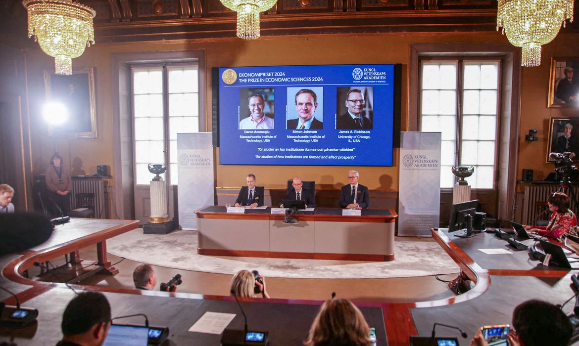 Academy of Sciences permanent secretary Hans Ellegren, Jakob Svensson and Jan Teorell, of the Nobel Assembly at the Swedish Riksbank announce the Swedish Riksbank's prize in economic science in memory of Alfred Nobel 2024, which goes to Daron Acemoglu, Simon Johnson and James A. Robinson, during a press meeting at the Royal Swedish Academy of Sciences in Stockholm, Sweden, October 14, 2024. REUTERS/Tom Little
