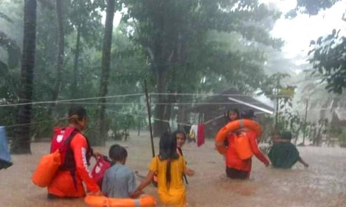 Rescue workers help people affected by floods in Philippines