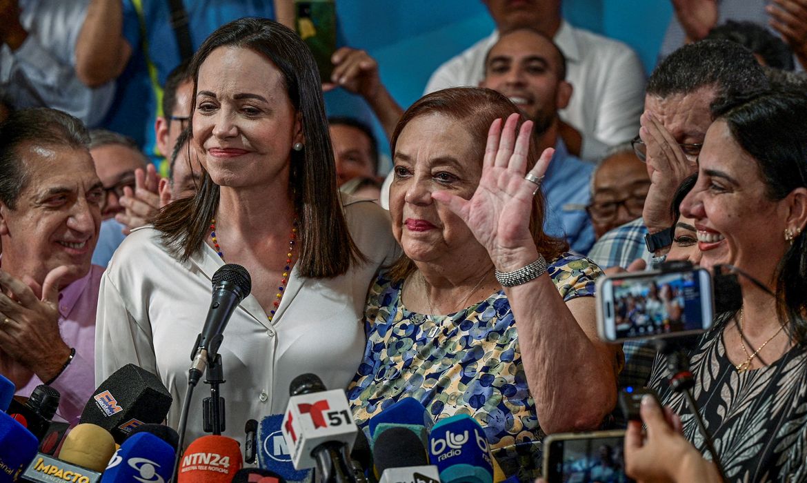 Venezuelan opposition leader Maria Corina Machado poses with Corina Yoris Villasana, whom she nominated to replace her as a presidential candidate, during a press conference in Caracas, Venezuela, March 22, 2024. REUTERS/Gaby Oraa