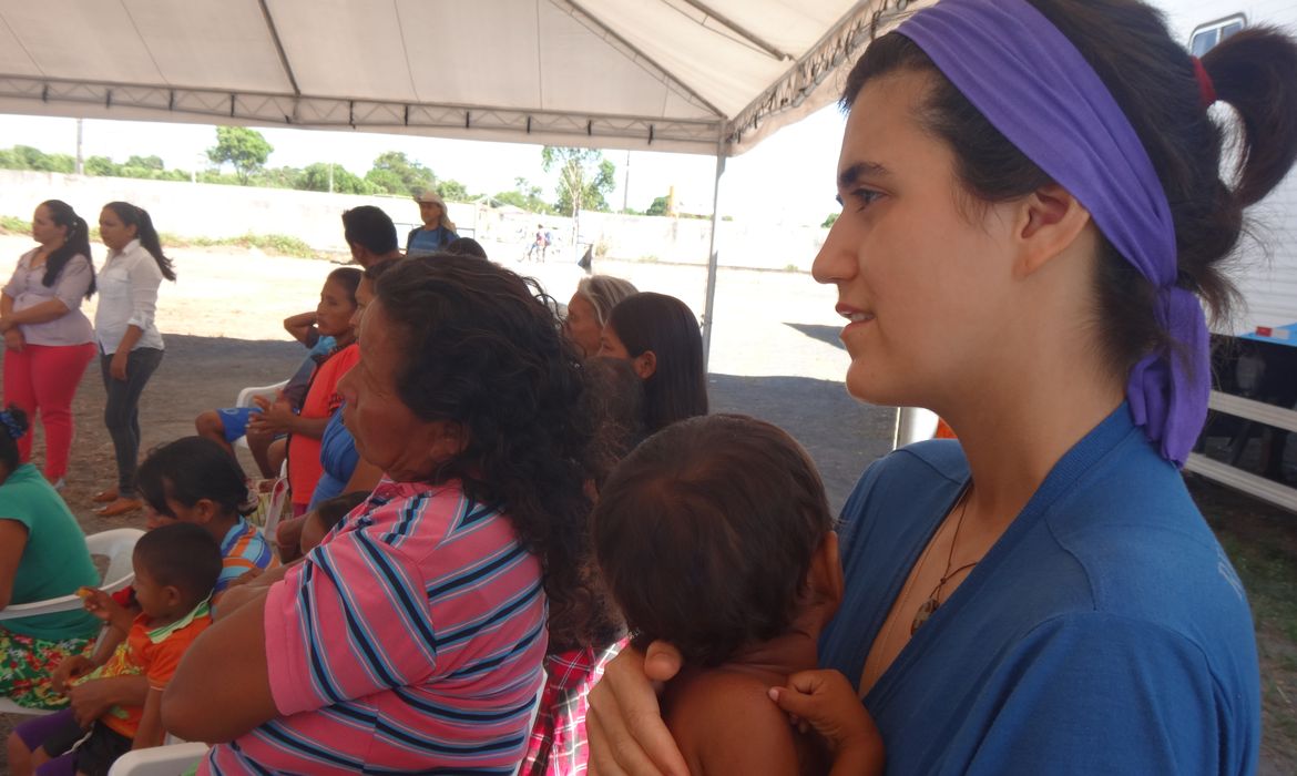 Voluntária com criança venezuelana no Centro de Referência ao Imigrante