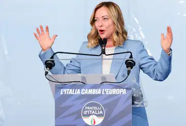 Italy's Prime Minister Giorgia Meloni gestures at a 