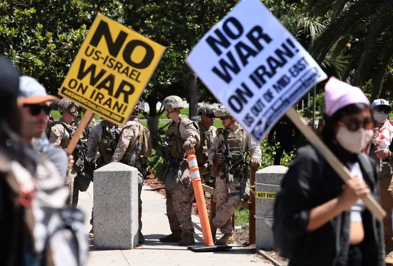 U.S. Marines stand guard as demonstrators protest against the United States joining with Israel in attacks on Iran's nuclear facilities, at a federal building in Los Angeles, California, U.S. June 22, 2025.  REUTERS/David Swanson