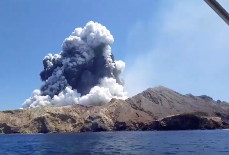 Smoke from the volcanic eruption of Whakaari, also known as White Island, is pictured from a boat, New Zealand December 9, 2019 in this picture grab obtained from a social media video. INSTAGRAM @ALLESSANDROKAUFFMANN/via REUTERS THIS IMAGE HAS