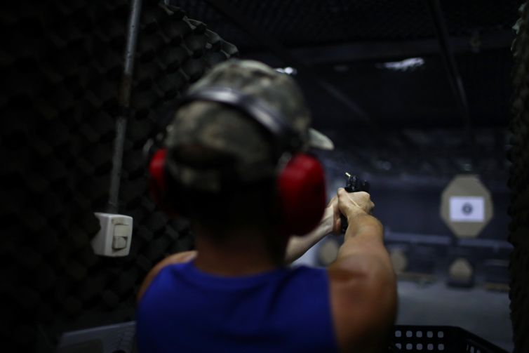 A member of the Colt 45 shooting club fires a gun in Rio de Janeiro, Brazil January 15, 2019. REUTERS/Pilar Olivares