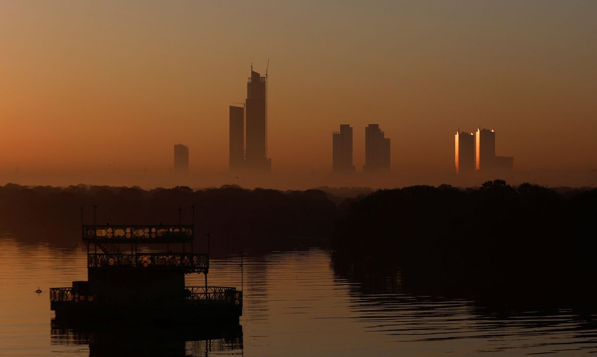 A view of buildings in morning fog as the first sun of the New Year rises in Karachi