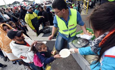 Refugiados provenientes da Hungria recebem doações de refeições na Áustria (Agência Lusa/Direitos Reservados)