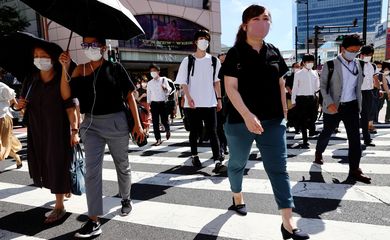 Pessoas usando máscaras de proteção caminham em Tóquio - transeuntes, pedestres- covid-19 - pandemia
