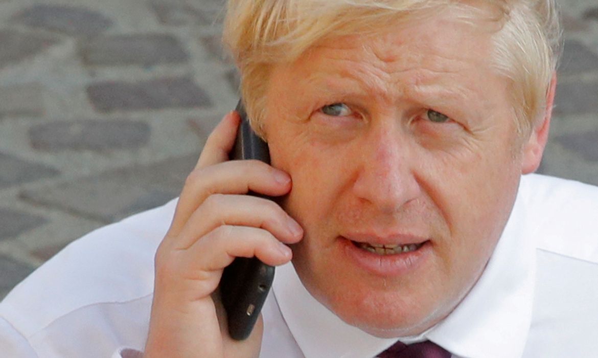 Britain's Prime Minister Boris Johnson makes a phone call as he walks near the summit venue during the G7 summit in Biarritz, France, August 25, 2019.  REUTERS/Philippe Wojazer