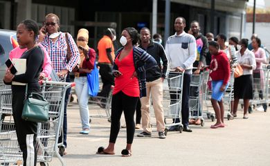 FILE PHOTO: People queue to shop ahead of a nationwide 21 day lockdown called by the government to limit the spread of coronavirus disease (COVID-19) in Harare