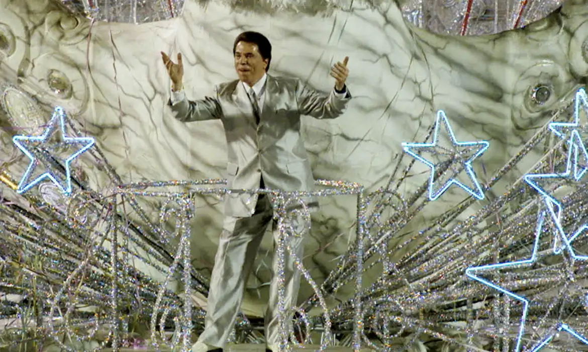 FILE PHOTO: Brazil's most famous TV personality and host of various game shows Silvio Santos waves to the crowd from atop his float for the 'Tradicao' samba school during a late-evening parade at the Sambadrome stadium in Rio de Janeiro February 25, 2001. Reuters/Paulo Whitaker/Proibida reprodução