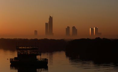A view of buildings in morning fog as the first sun of the New Year rises in Karachi