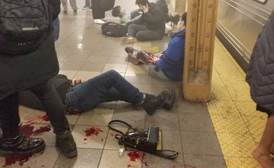 Wounded people lie at the 36th Street subway station, in New York City