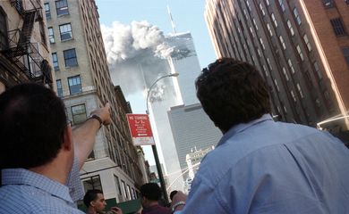 Pedestrians react to the World Trade Center collapse September 11, 2001. Two commercial airplanes cr..