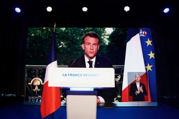 French President Emmanuel Macron speaks through a screen at the far-right National Rally (Rassemblement National - RN) party headquarters after the polls closed during the European Parliament elections, in Paris, France, June 9, 2024. REUTERS/Sarah Meyssonnier