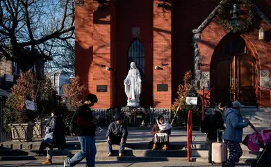 People gather outside Our Lady of Sorrows Catholic Church in the Corona neighborhood, a largely immigrant community, in the Queens borough of New York City, U.S., January 8, 2026.  REUTERS/Dana Edwards